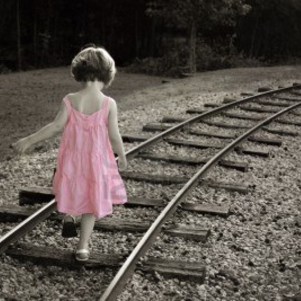 3596353 couleur noir et blanc avec une petite fille dans une robe rose de marcher sur la voie ferree